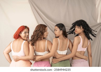 Four diverse models are posing together, showcasing different ethnicities and body types, promoting body positivity and inclusivity