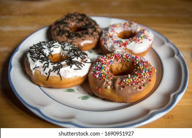 Four Doughnuts On White Plate