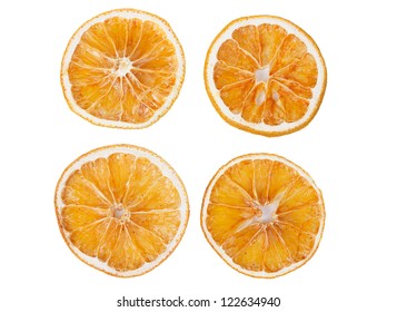four dried slices of orange isolated on white background