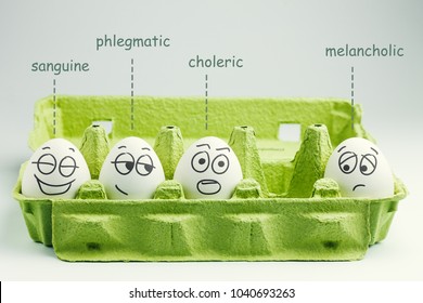 Four eggs in eggbox. Types of temperaments. Sanguine, choleric, phlegmatic and melancholic. - Shutterstock ID 1040693263