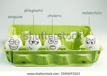 Four eggs in eggbox. Types of temperaments. Sanguine, choleric, phlegmatic and melancholic.