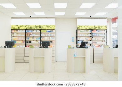 Four empty without visitors clients staff cash point desks at pharmacy drugstore chemist`s store with white shelves full of medicines, jars with pills, remedy - Powered by Shutterstock