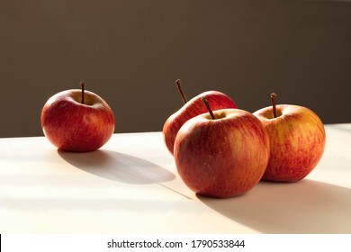 Four Equal Apples Expressing A Concept. Group Of Apples Representing Segregation, Racism, Prejudice And Other Similar Situations. Separating One And Placing It Close To An Edge.