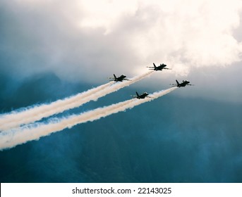 Four FA-18 Jets Of The U.S. Navy's Precision Flight Team, The Blue Angels, Fly In The Skies Of Hawaii.