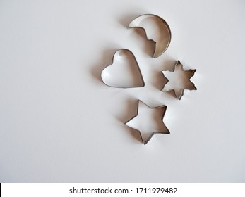 Four festive cookie cookie cutters on a white background.