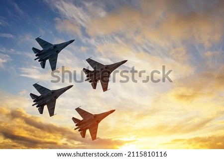 Four fighter jets in the shape of a diamond in the sky beautiful sunset