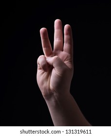 Four Fingers On A Black Background