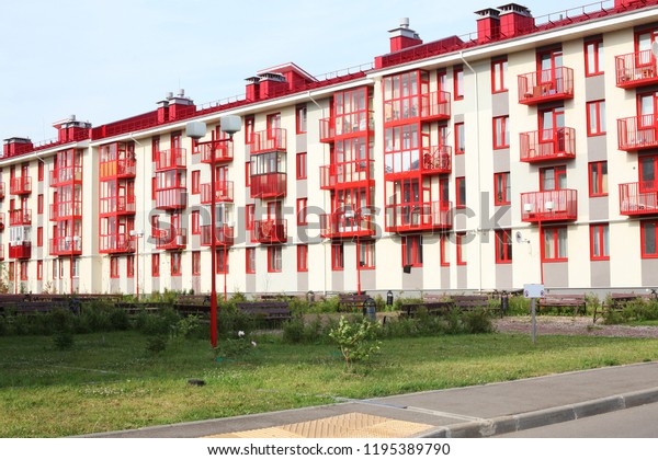 four floors\
apartment house, red and white\
facade