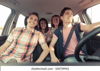 Four Friends In A Car Leaving For Vacation