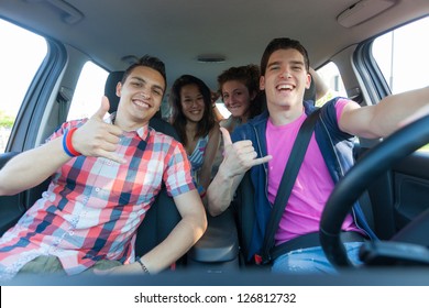 Four Friends In The Car Leaving For Vacation