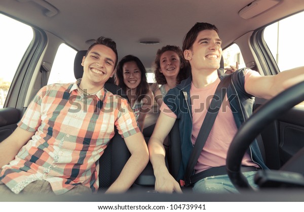 Four Friends in a\
Car Leaving For Vacation