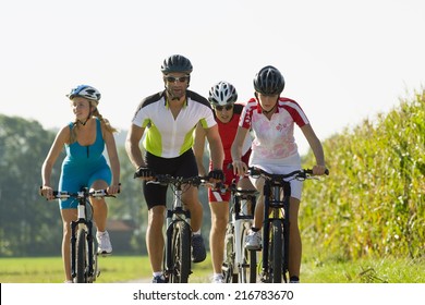 Four Friends Cycling Down The Road.