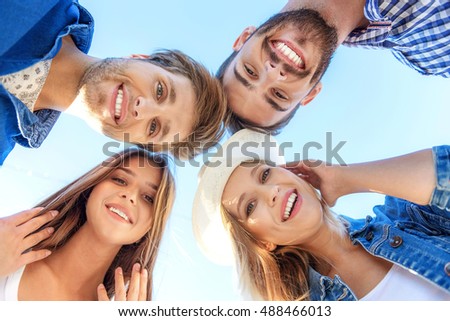 four friends fooling around outdoors
