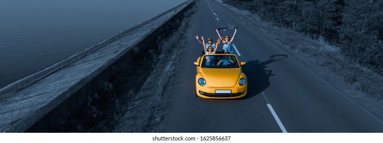 The four friends  traveling by cabriolet and fool around - Powered by Shutterstock