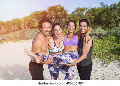 Four Friends With Yoga Clothing Enjoying On The Beach