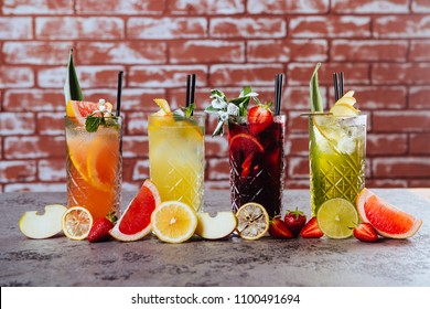 Four frowzen cocktails on table with tasty fruits on loft background. - Shutterstock ID 1100491694