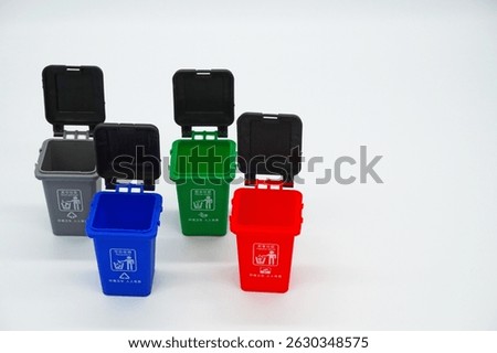 Four garbage classification bins on a white background