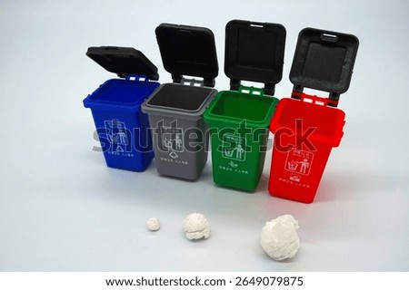 Four garbage classification bins on a white background