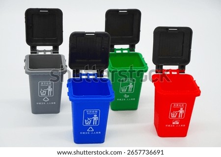 Four garbage classification bins on a white background