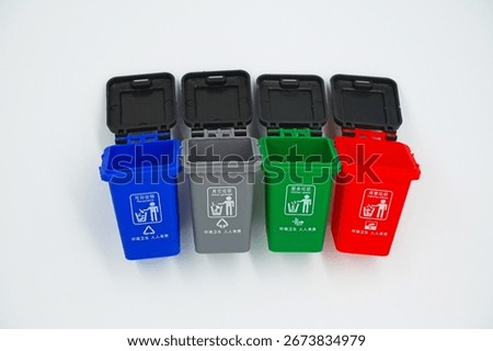 Four garbage classification bins on a white background