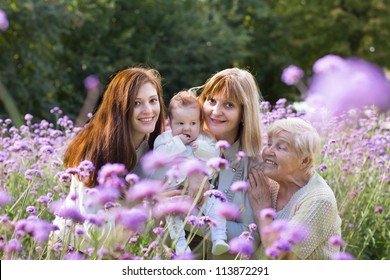 Four Generations Of Beautiful Women Standing In A Colorful Lavender Field