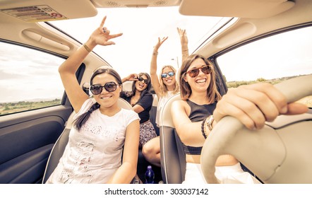 Four Girls Driving In A Convertible Car And Having Fun 