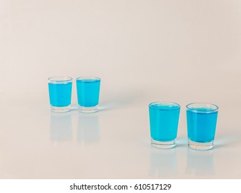 Four Glasses Of Blue Kamikaze, Glamorous Drink, Mixed Drink Poured Into Shot Glasses, Party Set