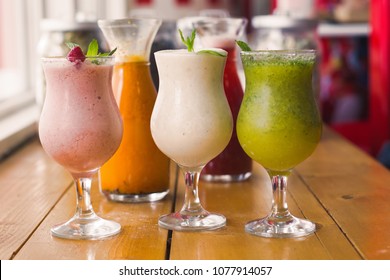 Four glasses of different smoothies