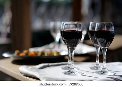 Four glasses with red wine on a sun