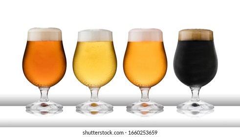 Four glasses of refreshing lager, beer, cider and stout, in  schooner glasses, with condensation, on a white table top and white background - Powered by Shutterstock