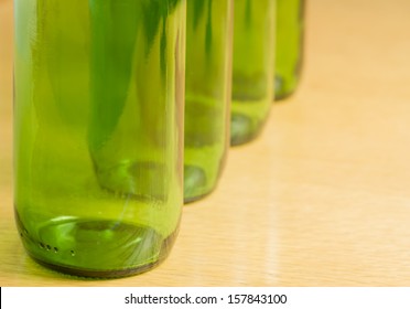 Four green bottles in a row