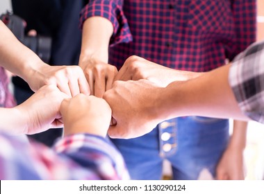 Four hand together in business meeting for Success team concept, Casual business people fist bump together for team togetherness Unity concept 