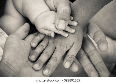 Four hands. Concept of love, friendship, happiness in family. Black and white shot. - Powered by Shutterstock