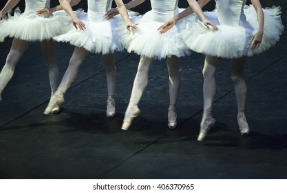 Four hands crossed dancing in the performance of Swan Lake