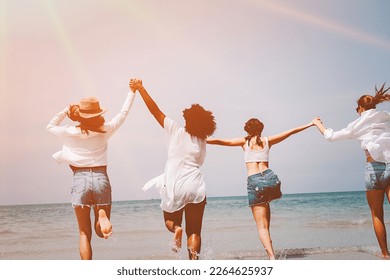 Four happy friends at sunset beach party runs to water, Silhouette group of teens holding hands and running together at the sunset sea, friendship and teamwork concept. - Powered by Shutterstock