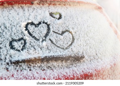 Four Hearts (symbol Of Love) Hand Drawing (painted) On Snow Above Windshield Wiper Of Car With Sunlight (blik Of Sun). Valentines Day, Love, Honeymoon, Winter, Transport Concept. Copy Space. 