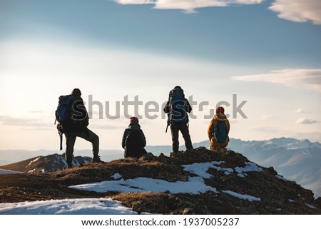 Four hikers are relaxing on mountain top