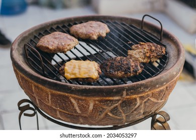 Four Homemade Cheeseburgers Grilling At Backyard Bbq Burnt