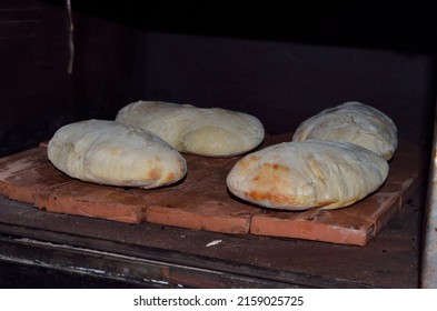 The Four Homemade Pita Breads Inside The Oven