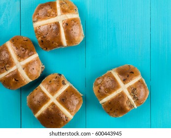 Four Hot Cross Buns Easter Food Against A Blue Background