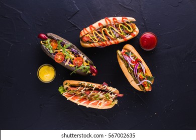 Four Hot Dog On A Dark Background (top View)