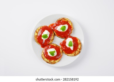 four hot pancakes with strawberry jam on white plate - Powered by Shutterstock