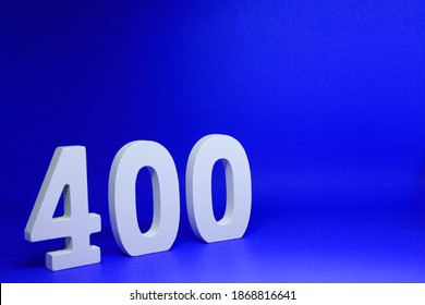 Four Hundred ( 400 ) white number wooden  Isolated blue Background with Copy Space - New promotion 400% Percentage  Business finance Concept                              