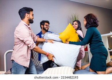 Four Indian Friends Fighting Pillows At Home