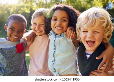 Four kids hanging out together in the garden - Shutterstock ID 1065441956