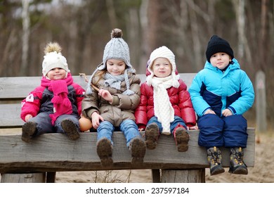 Four Kids Having Fun On Early Spring Or Late Autumn