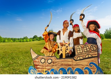 Four Kids In Pirate Costumes Behind Ship