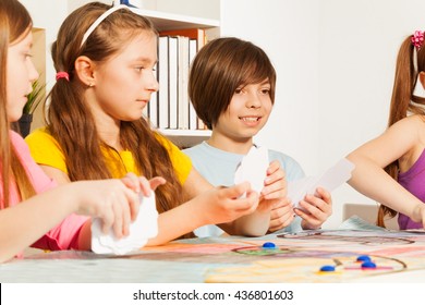 Four Kids Playing Cards For A Pastime