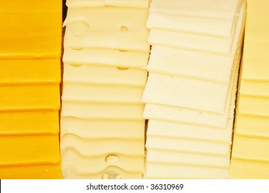 Four Kinds Of Sliced Cheeses At A Deli Counter