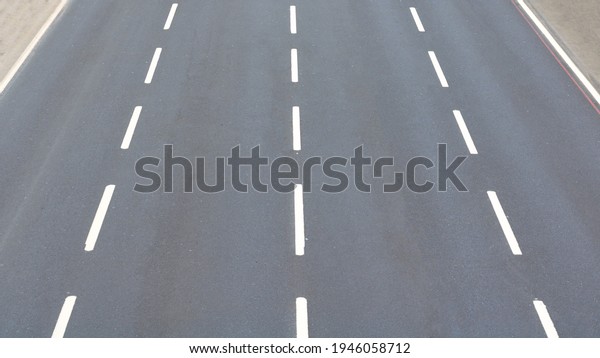 Four\
lane road with no cars. Empty road. Highway, road, travel, city\
background photo. Transportation background photo.\
